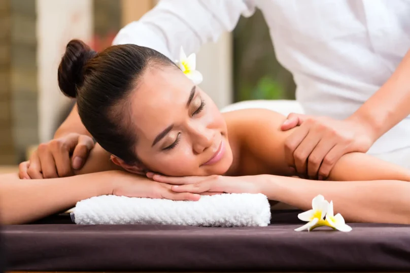 Indonesian Asian woman in wellness beauty day spa having aroma therapy massage with essential oil, looking relaxed