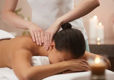 Portrait of beautiful woman enjoying massage in luxury spa by candlelight, copy space