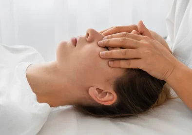 female-osteopathist-treating-patient-by-massaging-her-face