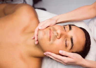 Man getting a facial massage for cosmetic treatment at clinic