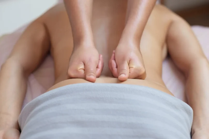 Caucasian woman getting a back massage in the spa salon. Body care concept.