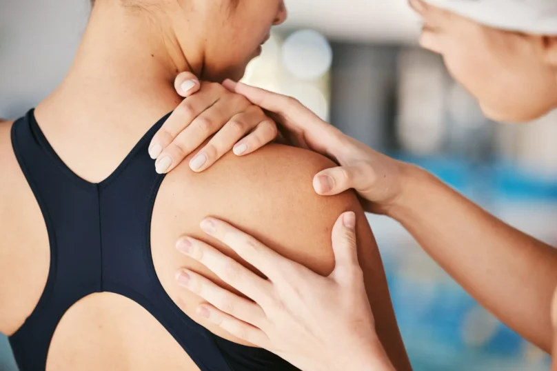 Closeup, shoulder pain or girl swimmer with injury after exercise, training or workout accident eme.