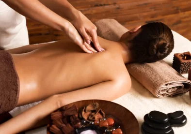 Massotherapist  doing massage on womans back in the spa salon.